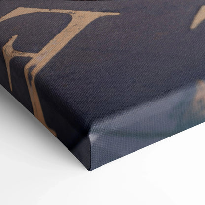 Close-up of dark canvas wall art corner with fine texture and muted beige print edges.