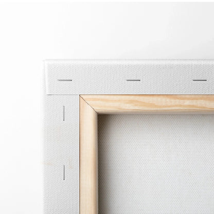 Close-up of wooden frame corner with white canvas stretched and stapled, showcasing museum-quality wall art craftsmanship.