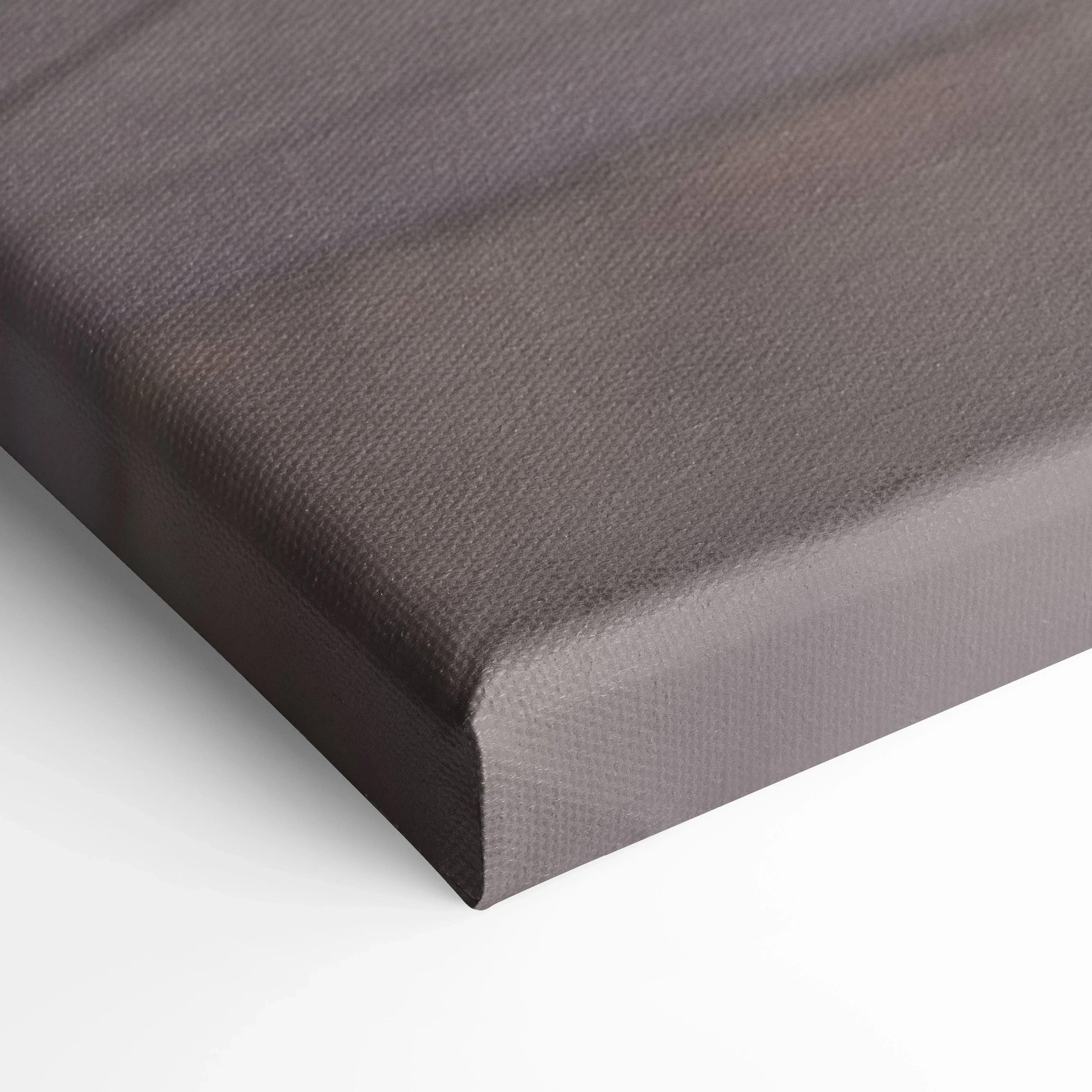 Close-up of a canvas wall art corner with brown textured fabric and wrapped edges.