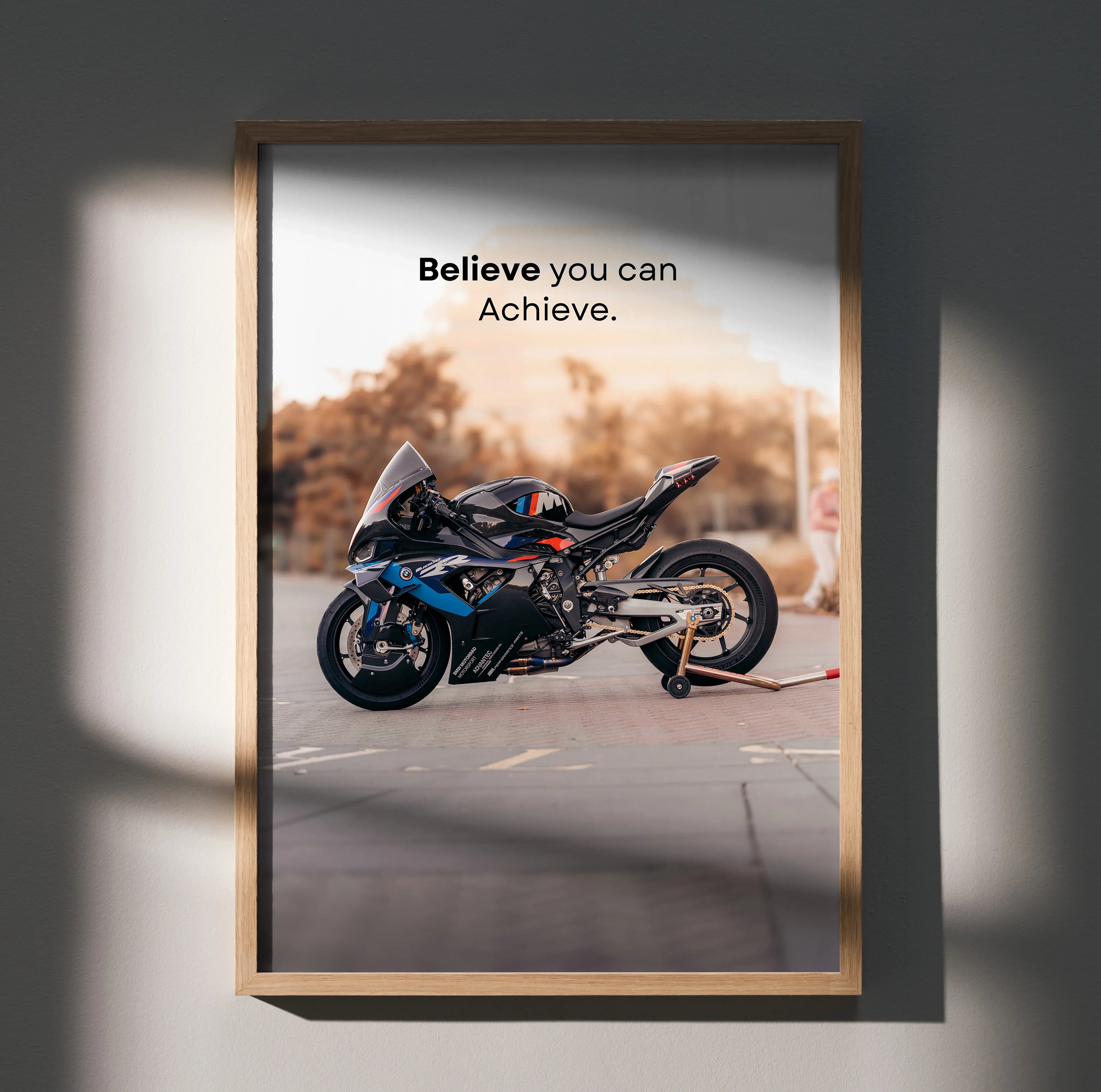 BMW M1000RR motivational poster wall art with "Believe you can Achieve" text and motorcycle image.