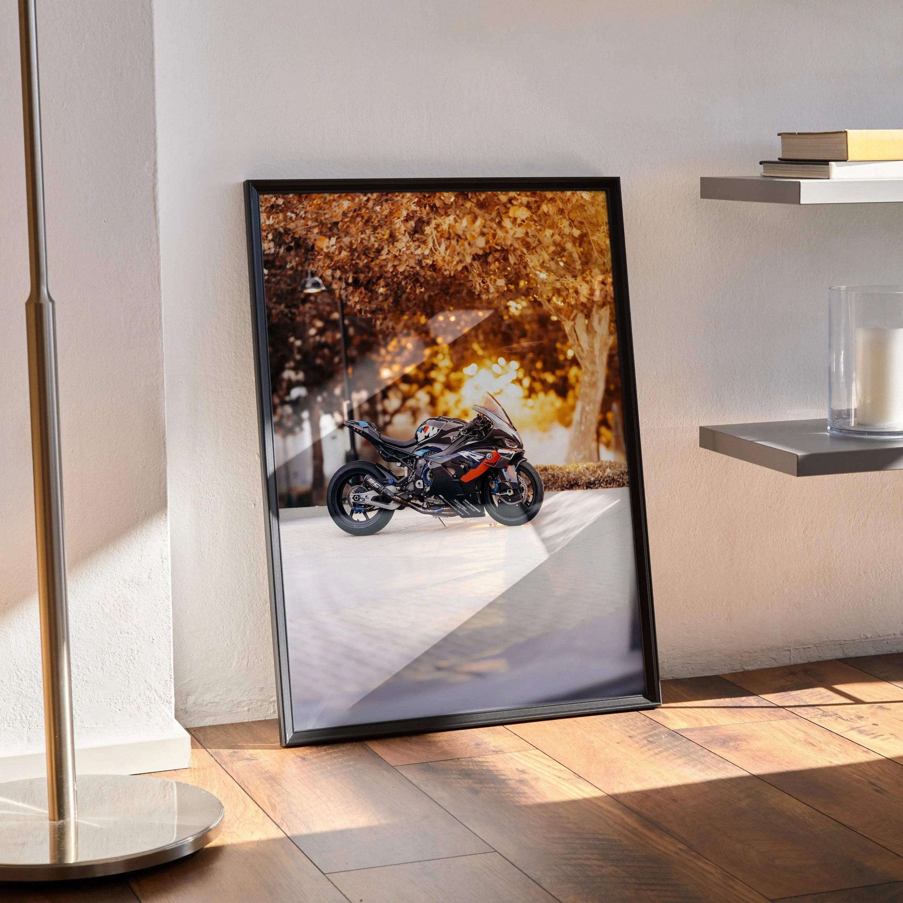 BMW M1000RR motorcycle poster with sunset backdrop and autumn leaves wall art in black frame.