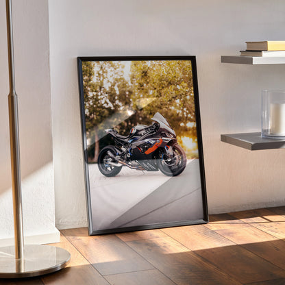 BMW M1000RR motorcycle poster with sleek black frame, displayed as wall art leaning on floor.