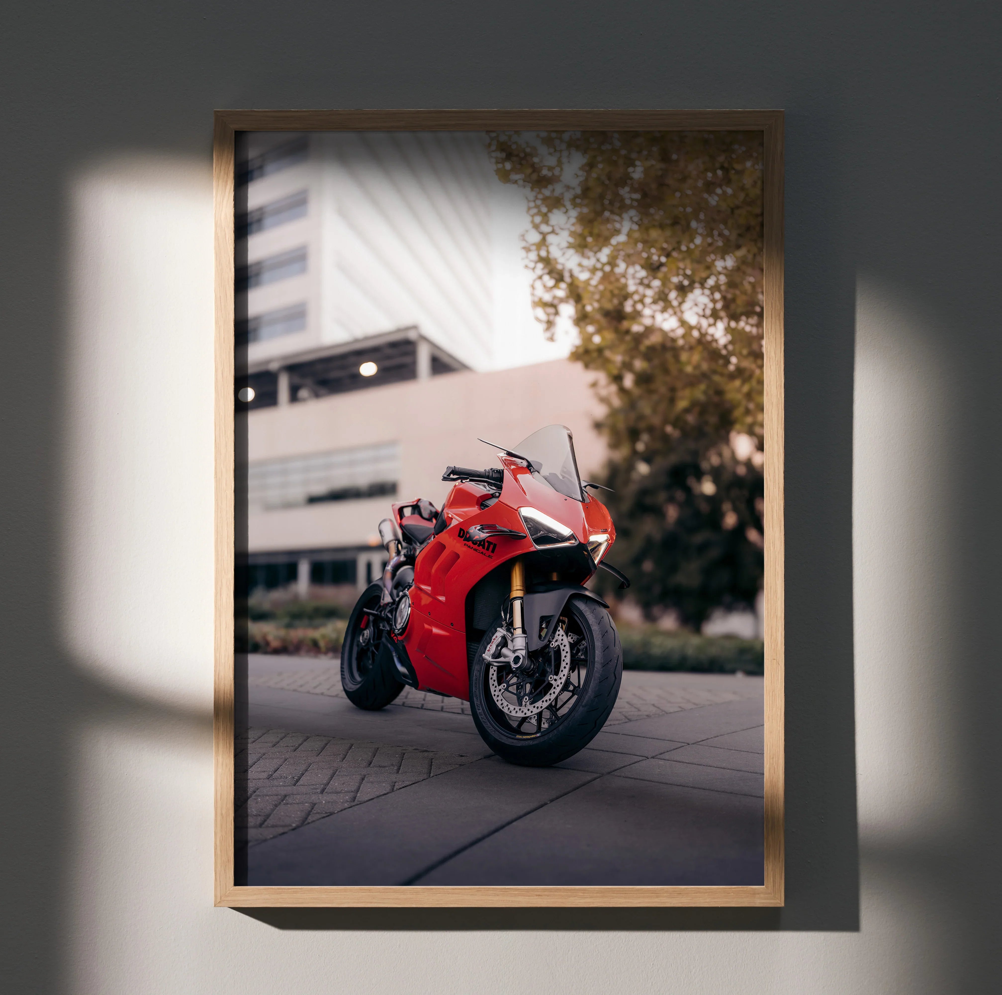 Ducati Panigale V4S motorcycle poster in sleek wooden frame, vibrant red bike against urban backdrop wall art.