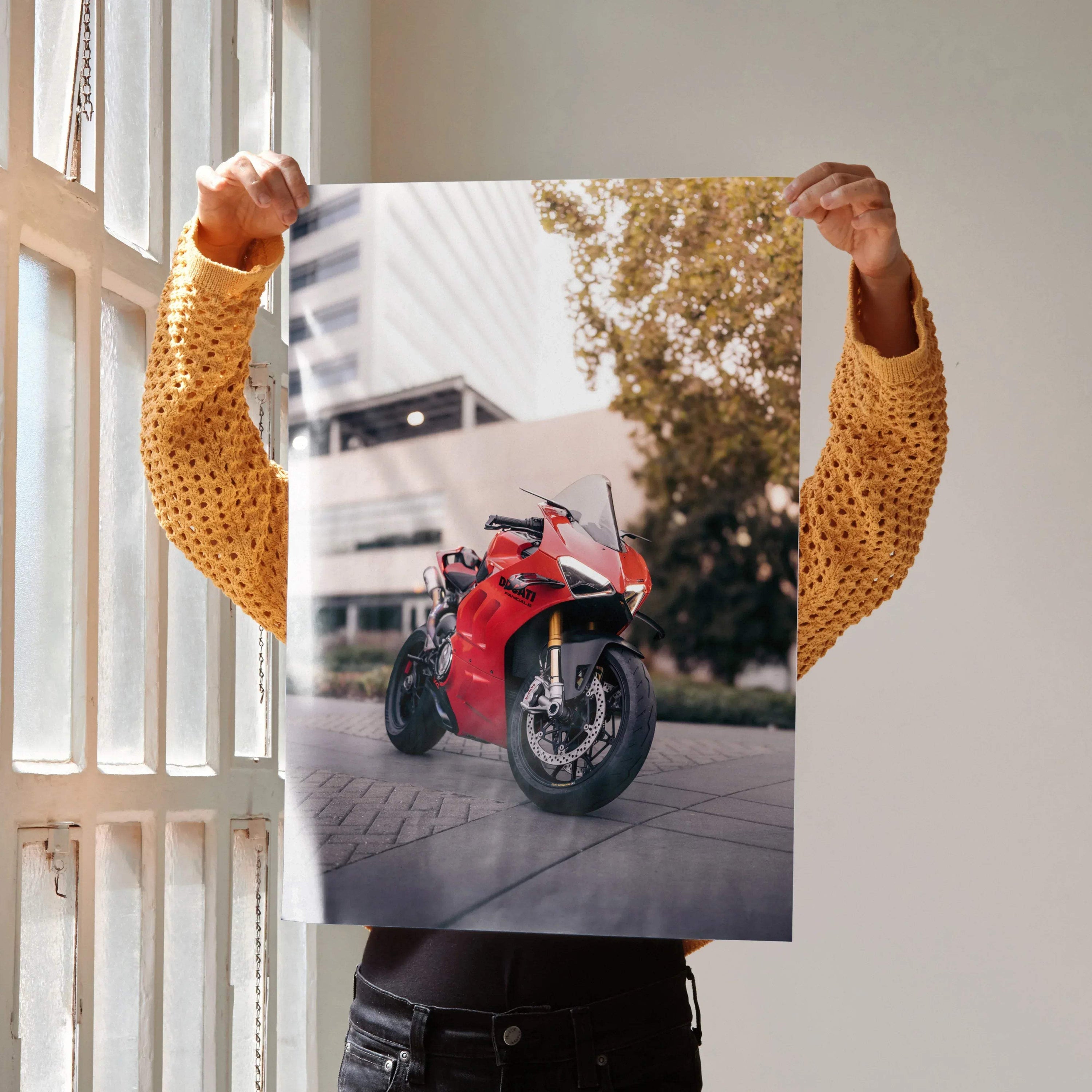 Ducati Panigale V4S motorcycle poster held indoors, vibrant red sportbike wall art.