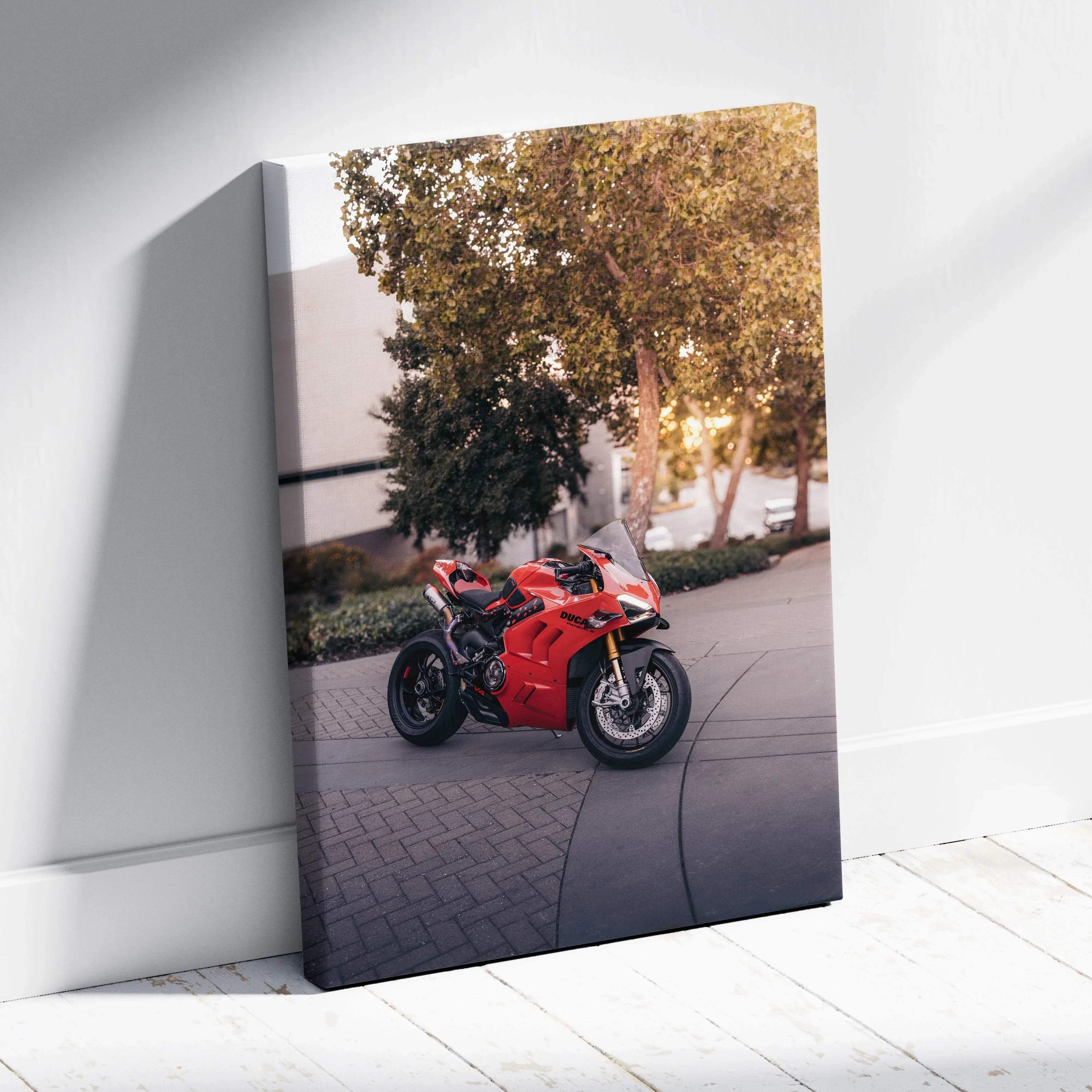 Vertical canvas wall art featuring a red Ducati Panigale V4S motorcycle outdoors with trees and building backdrop.