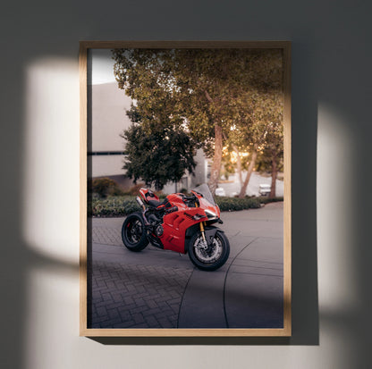 Red Ducati Panigale V4S motorcycle poster wall art in wooden frame with outdoor background lighting.