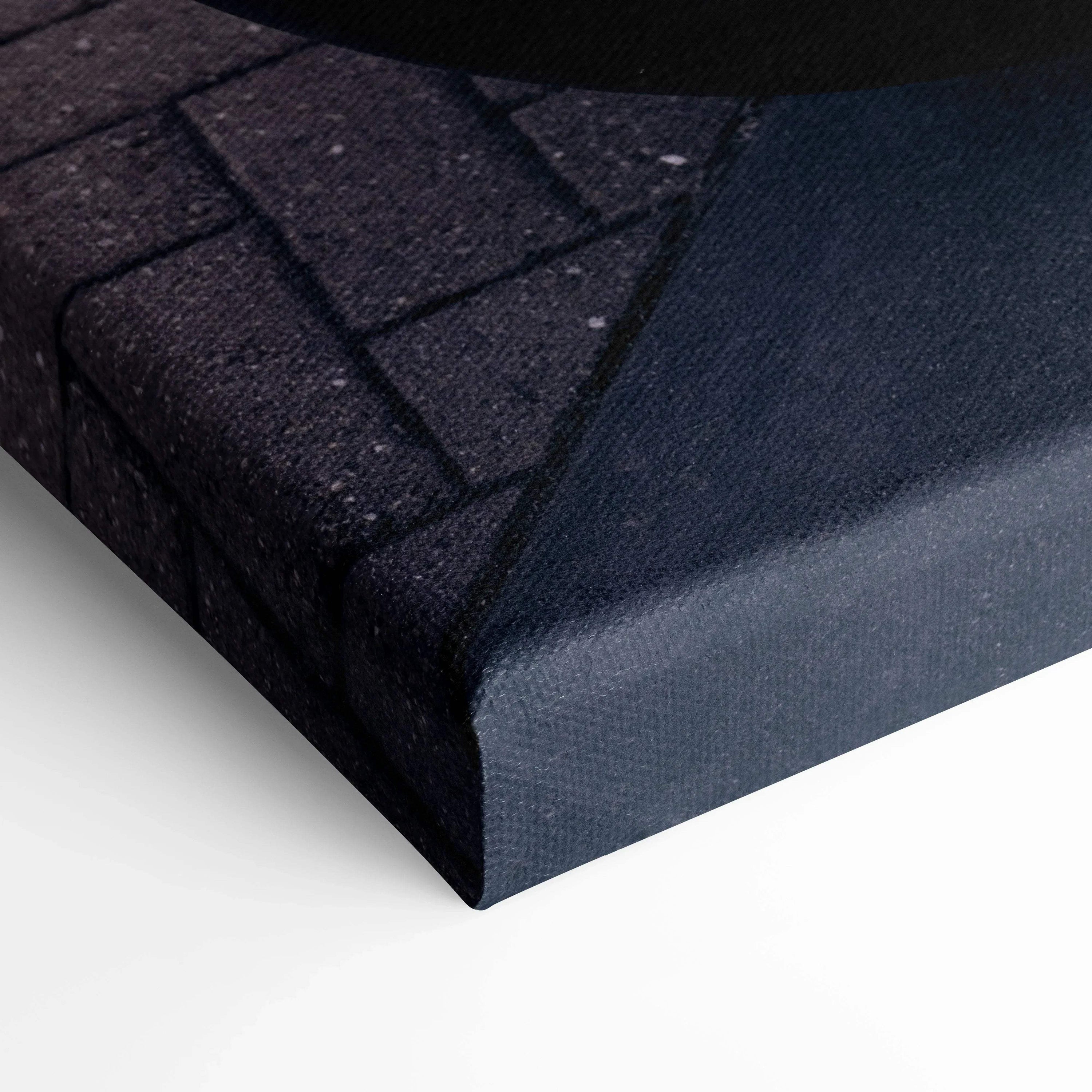 Close-up of black wrapped canvas corner with textured fabric, showcasing museum-quality wall art print surface.