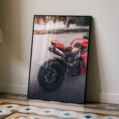 Ducati Panigale V4S motorcycle poster wall art with vibrant red sportbike detail leaning against a beige wall.