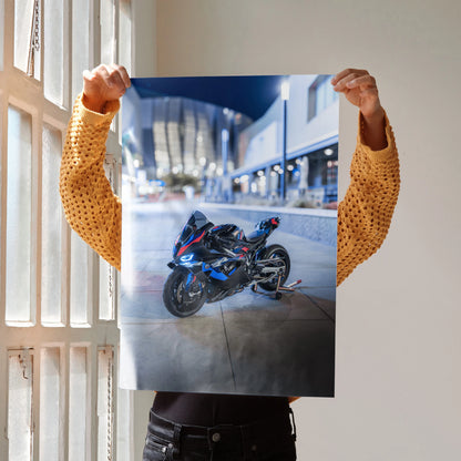 BMW M1000RR motorcycle poster showcasing sleek black sportbike on urban street, wall art for enthusiasts.