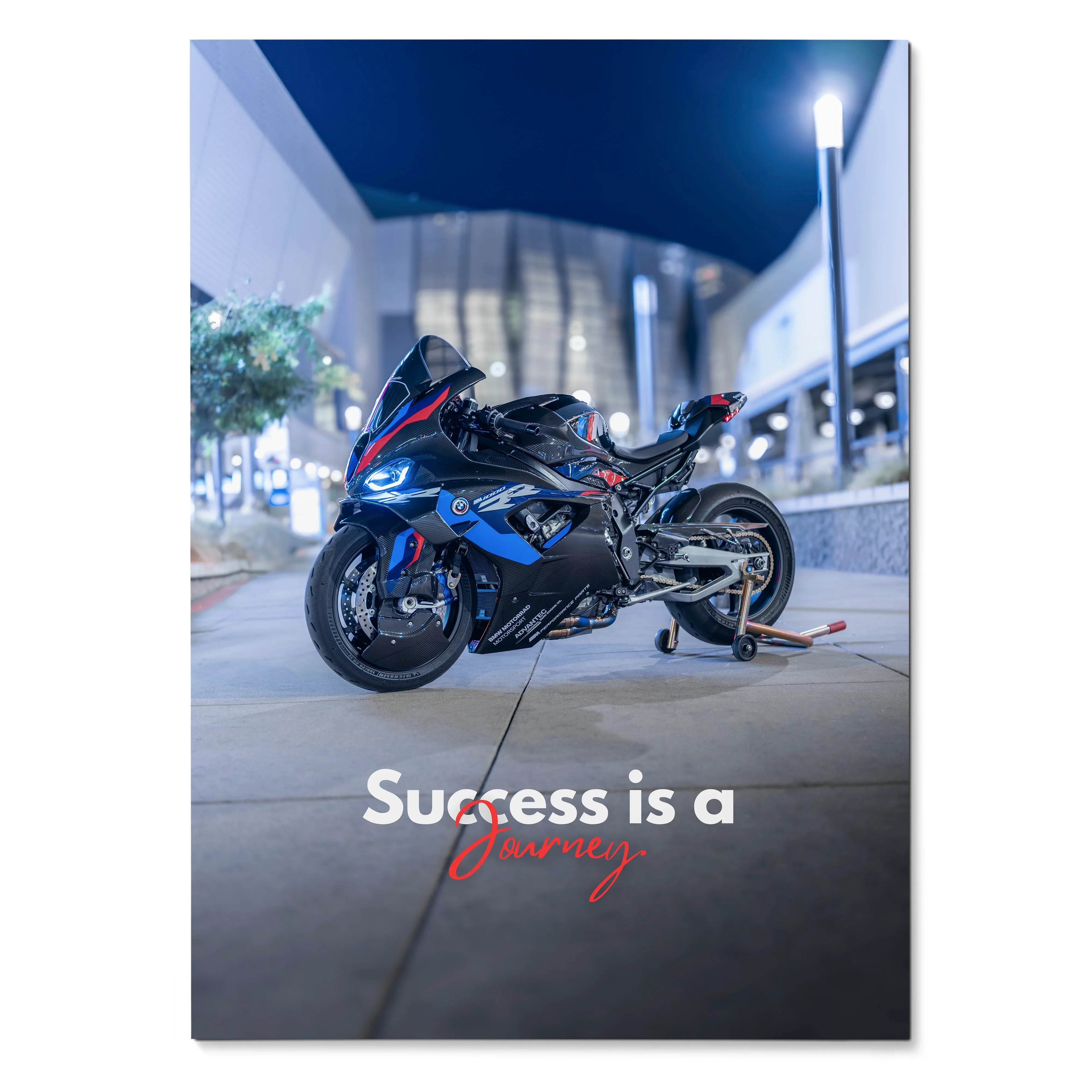 BMW M1000RR motorcycle poster wall art with "Success is a journey" text at night.