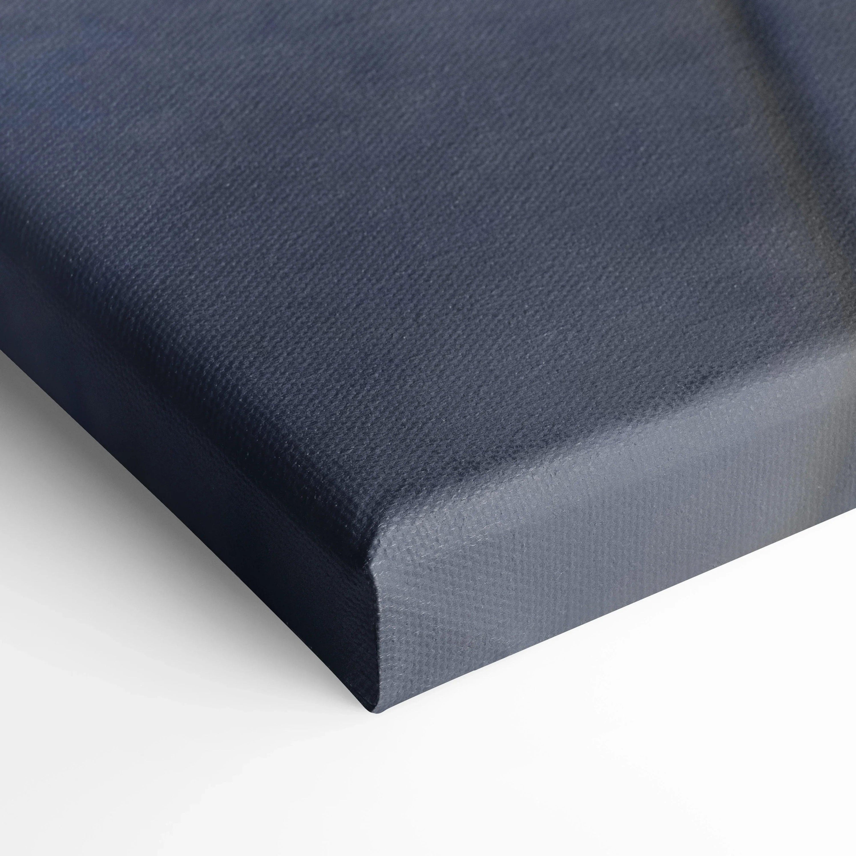 Close-up of dark textured canvas corner showcasing high-quality canvas art with deep stretch on white background.