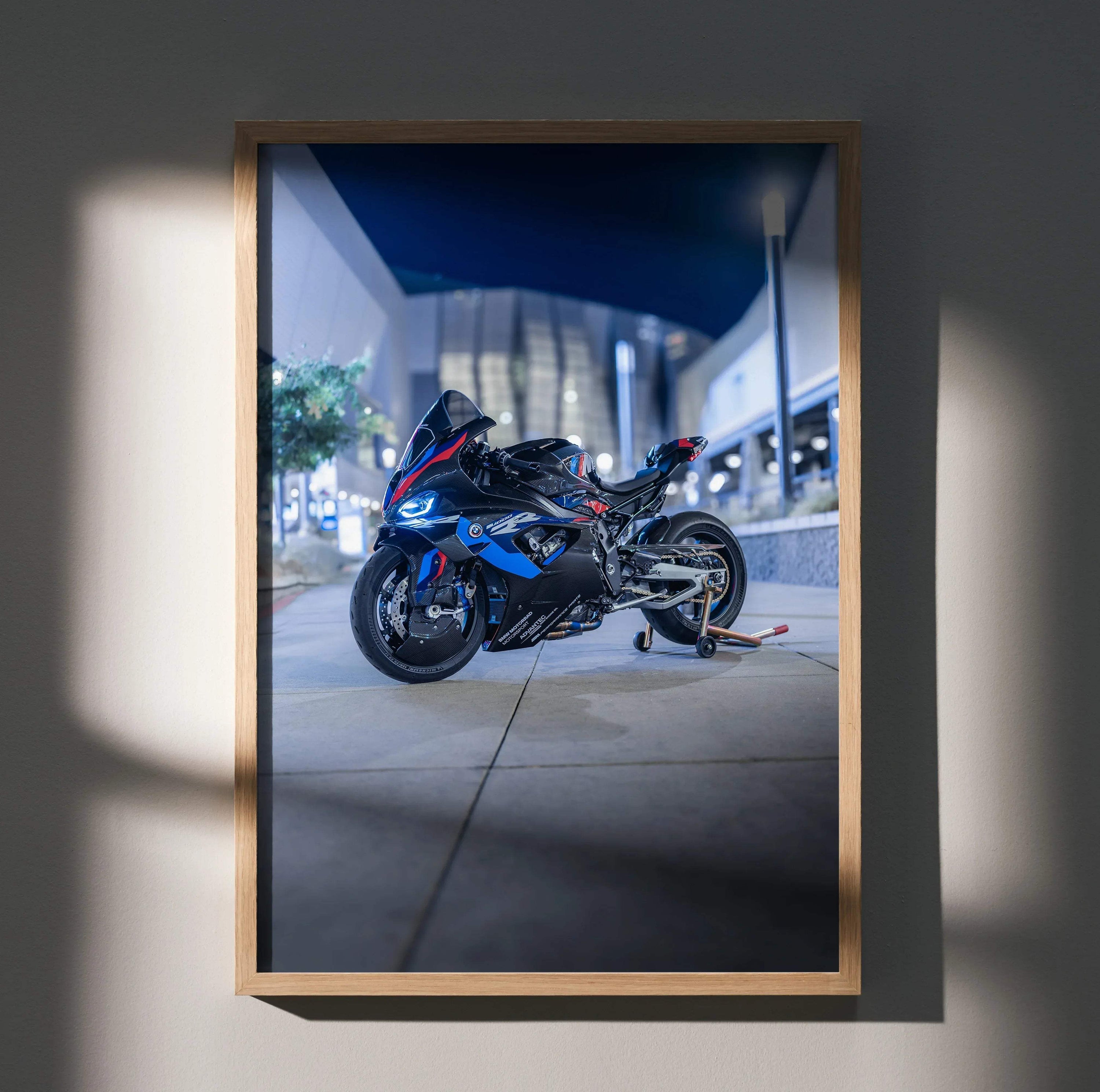 BMW M1000RR motorcycle poster with dynamic urban night scene in sleek black and blue colors wall art.