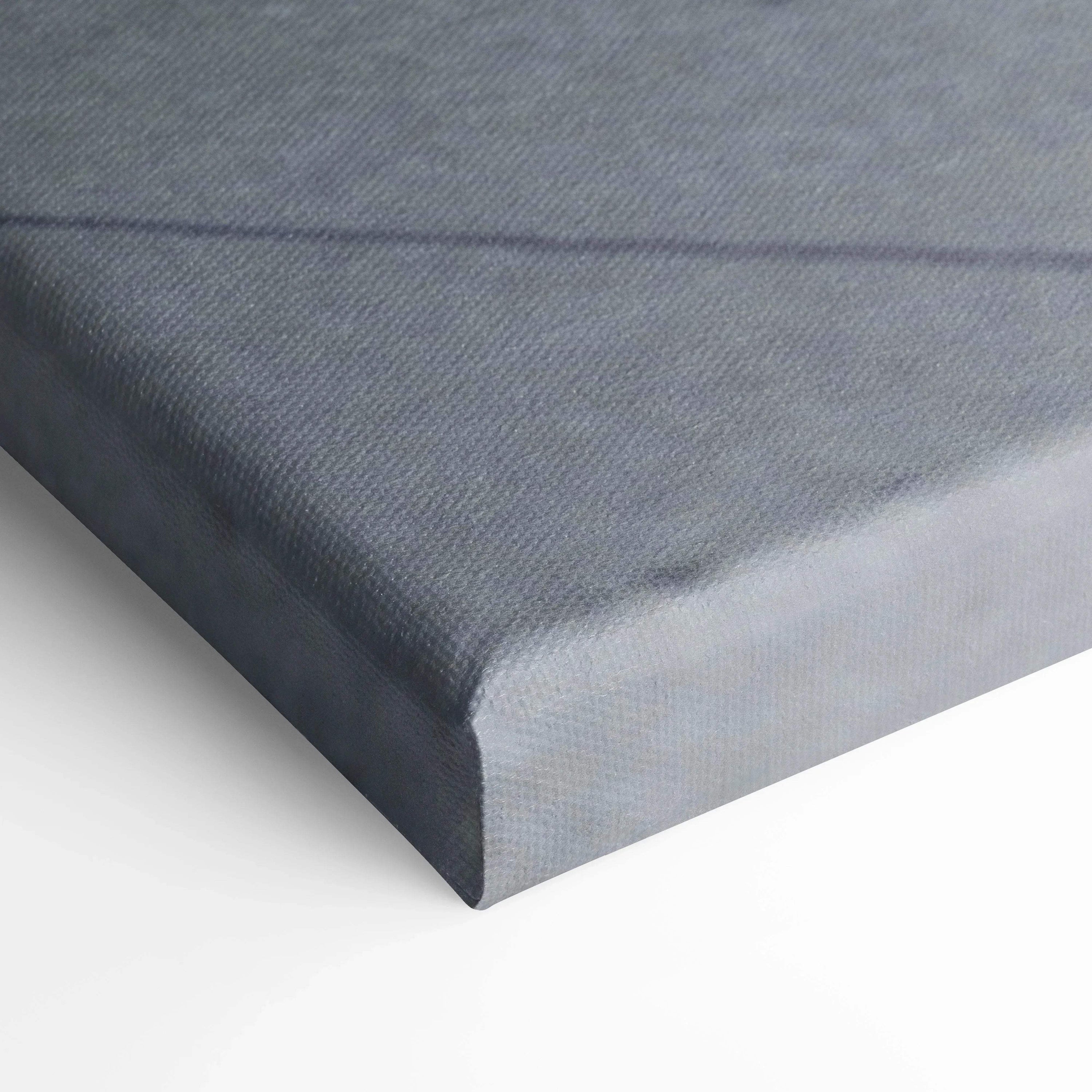 Close-up of wrapped gray canvas art corner with fine texture for wall art display.