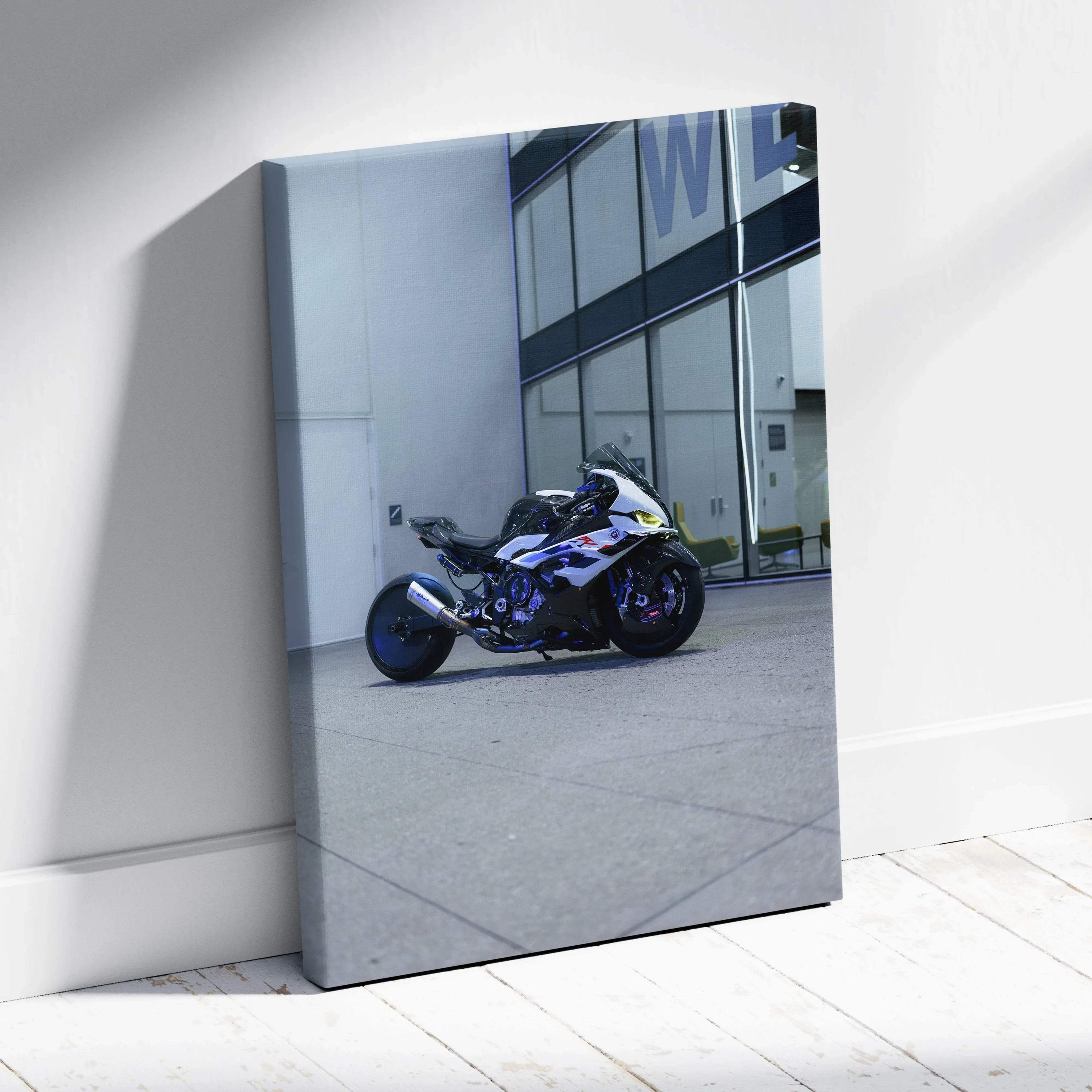 Vertical canvas art featuring a blue and white BMW S1000RR motorcycle parked by glass building wall.