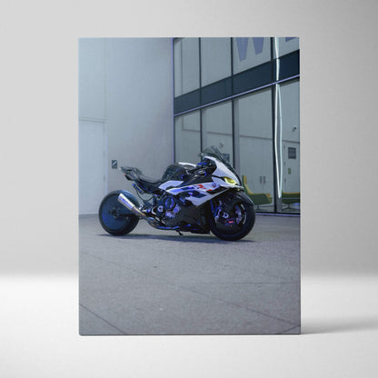 Vertical canvas art featuring a BMW S1000RR motorcycle parked by a modern glass building wall art print.