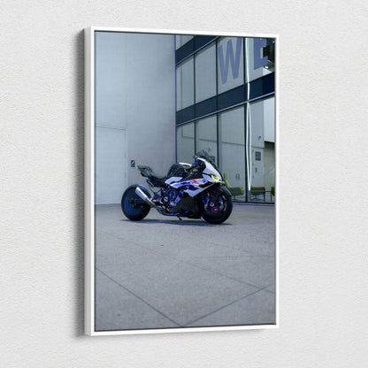 Vertical canvas wall art featuring a BMW S1000RR sportbike parked against a modern building facade.