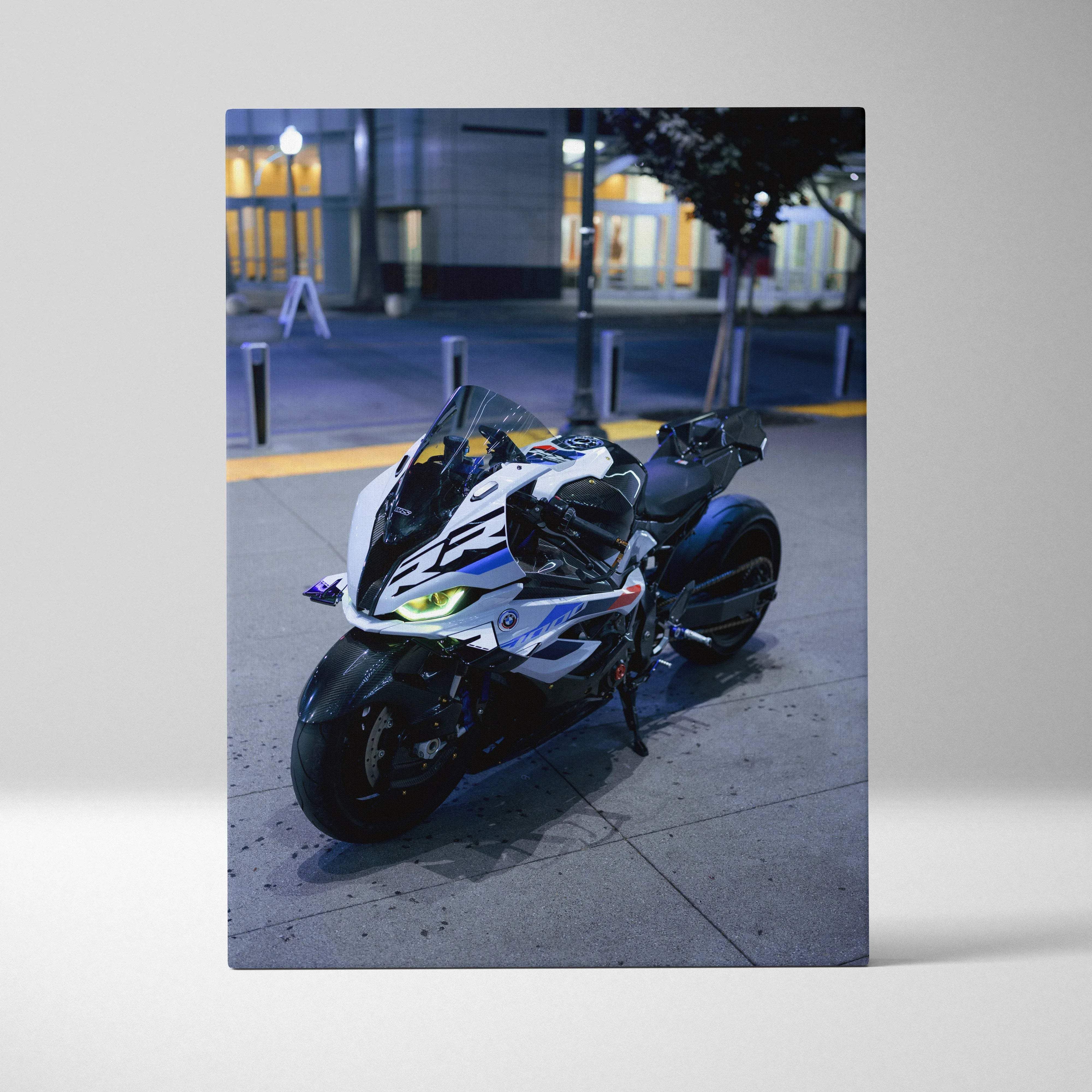 Canvas wall art of a white and black sport motorcycle with blue accents and glowing headlights in night ride mood