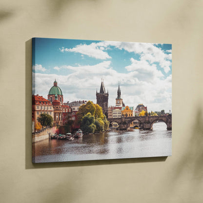 Canvas wall art featuring vibrant digital art of historic buildings along a river under a blue sky.