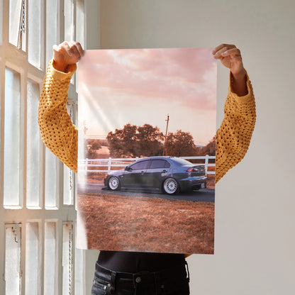 Mitsubishi Evo 10 poster with high-resolution wall art showing car on dirt road at sunset.