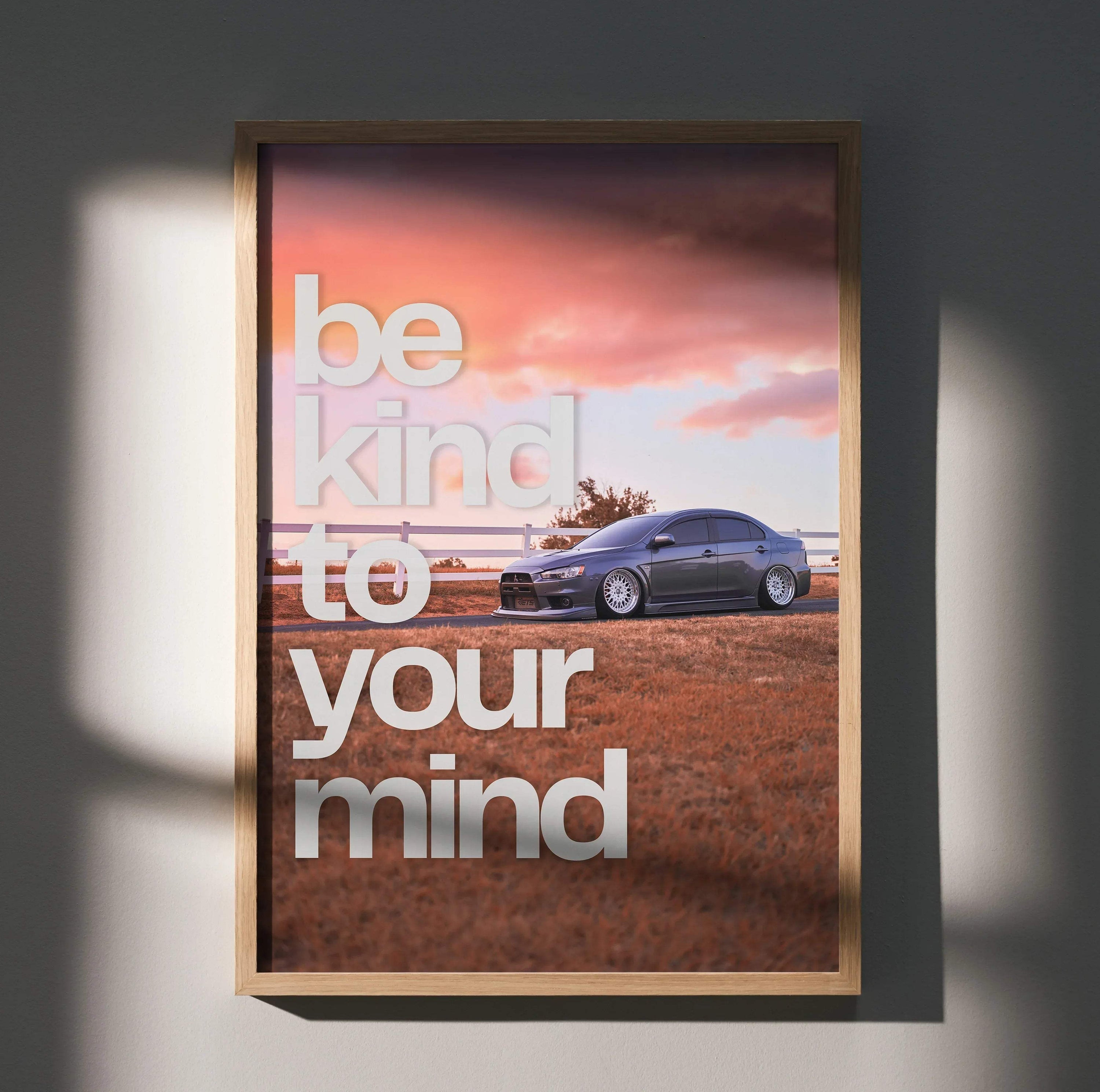 Motivational poster wall art with Mitsubishi Evo 10 and text "Be kind to your mind" against sunset sky.