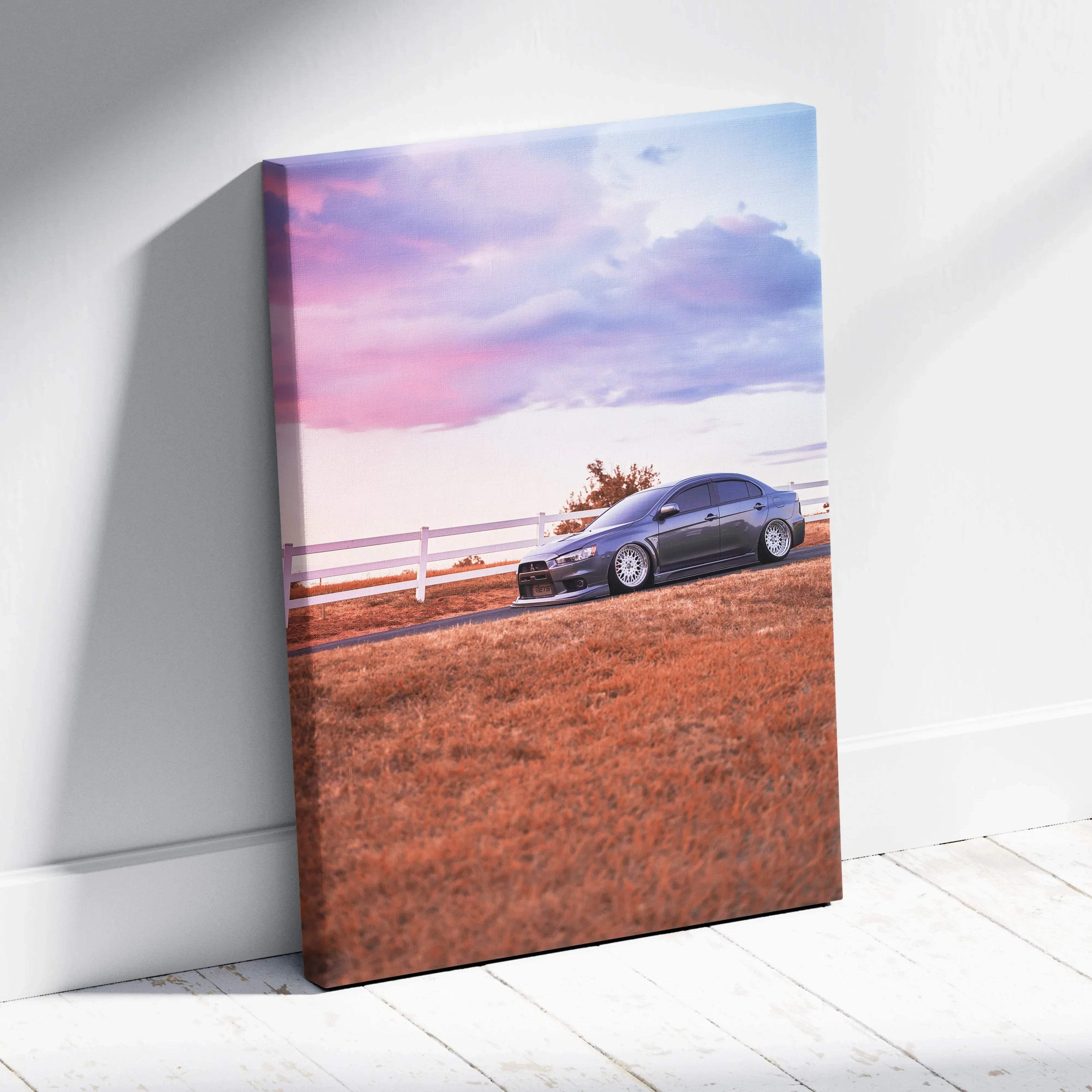 Mitsubishi Evo 10 parked on dry grass with vibrant sunset sky canvas wall art.