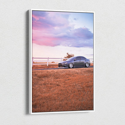 Vertical canvas wall art of Mitsubishi Evo 10 parked on grass at sunset with pink and purple sky.