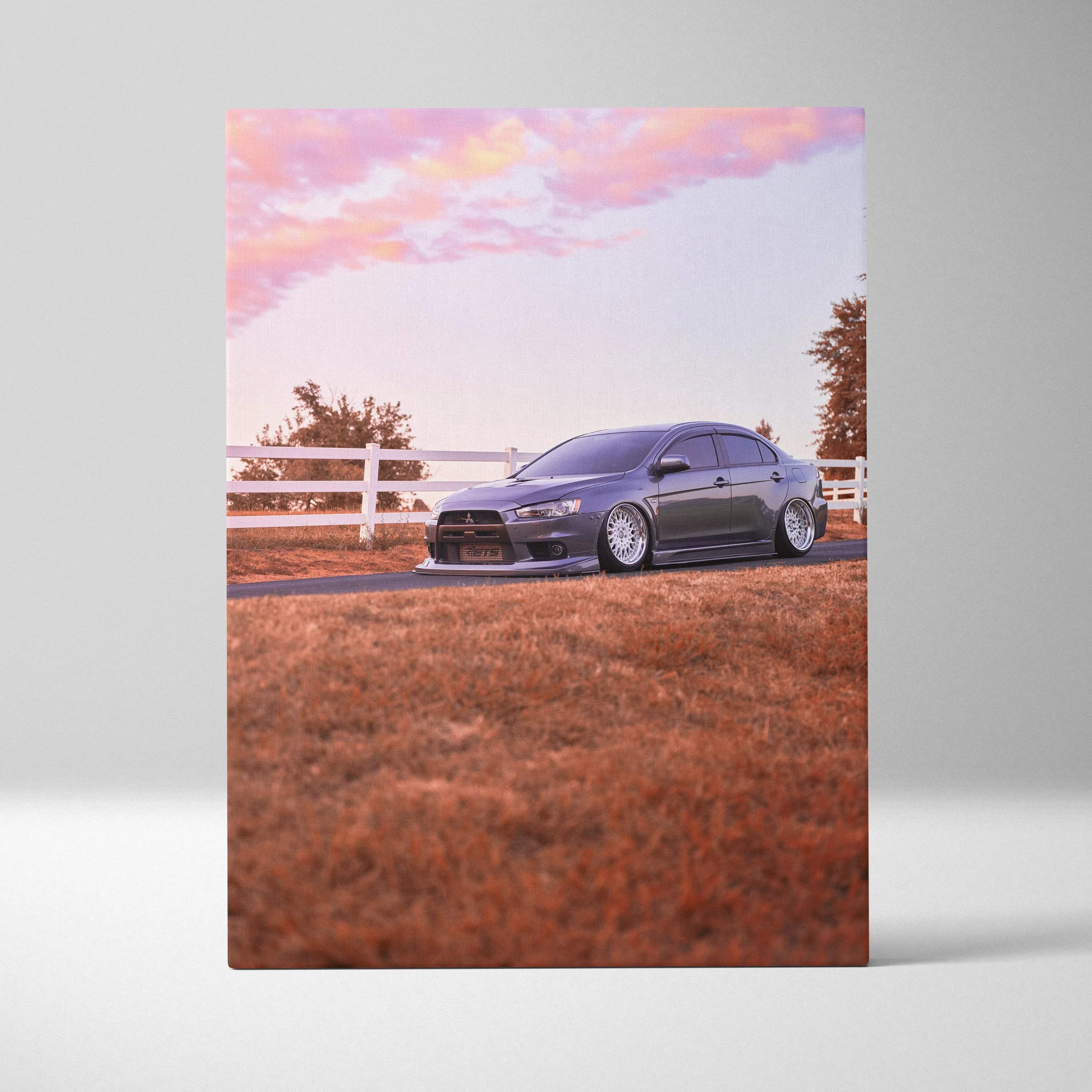 Mitsubishi Evo 10 parked on grass with orange sky background canvas wall art.