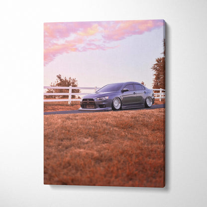 Mitsubishi Evo 10 parked on grass near white fence at sunset canvas wall art.