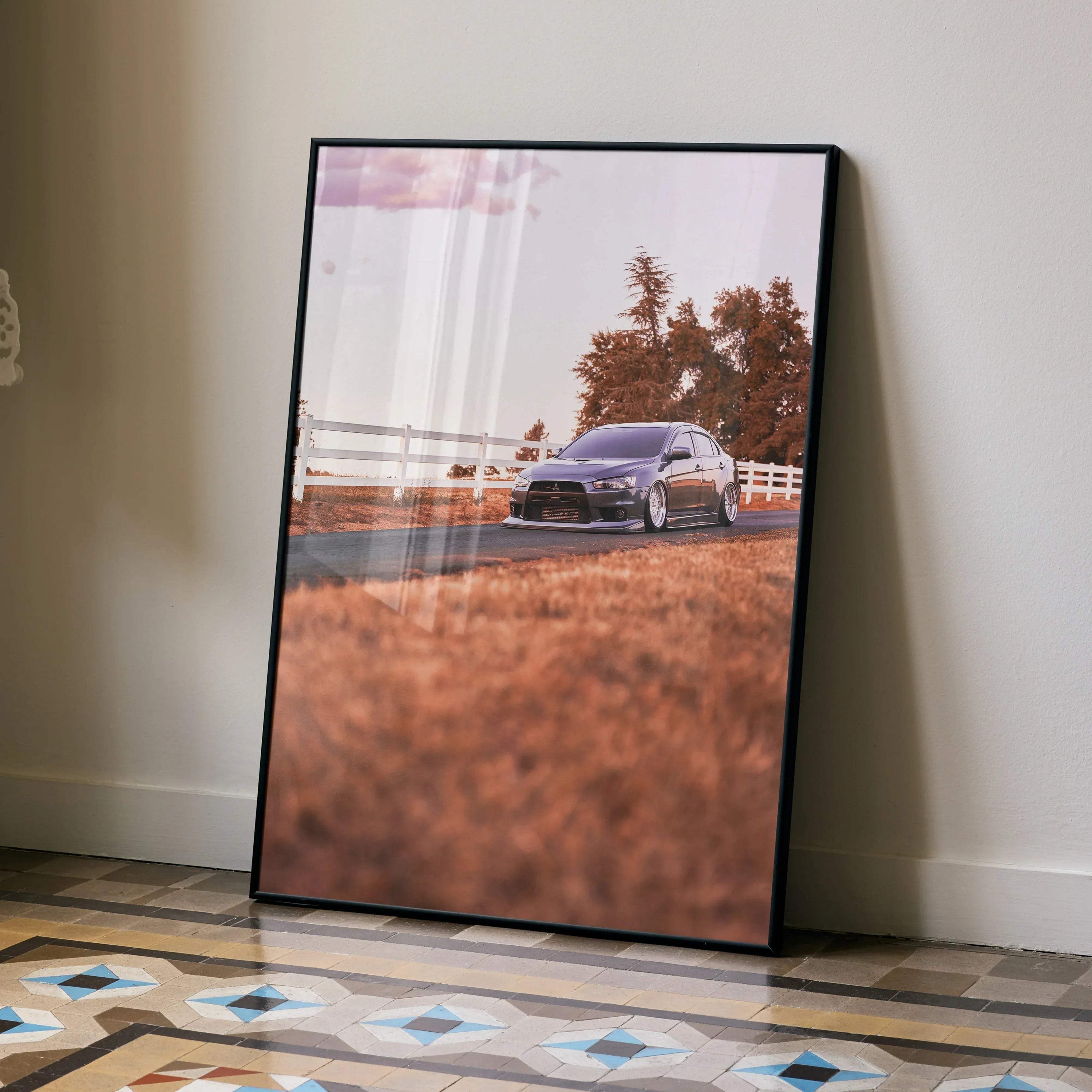 Mitsubishi Evo 10 poster wall art featuring a black car on an autumn road with trees and fence.
