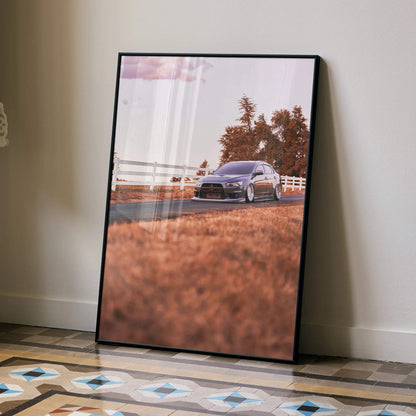 Mitsubishi Evo 10 poster wall art featuring a black car on an autumn road with trees and fence.