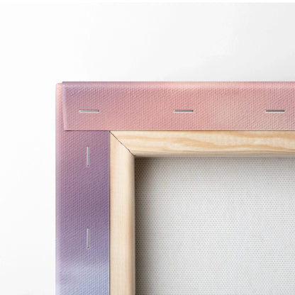 Close-up of wooden frame and fabric backing of vertical canvas wall art with purple-pink gradient wrap.