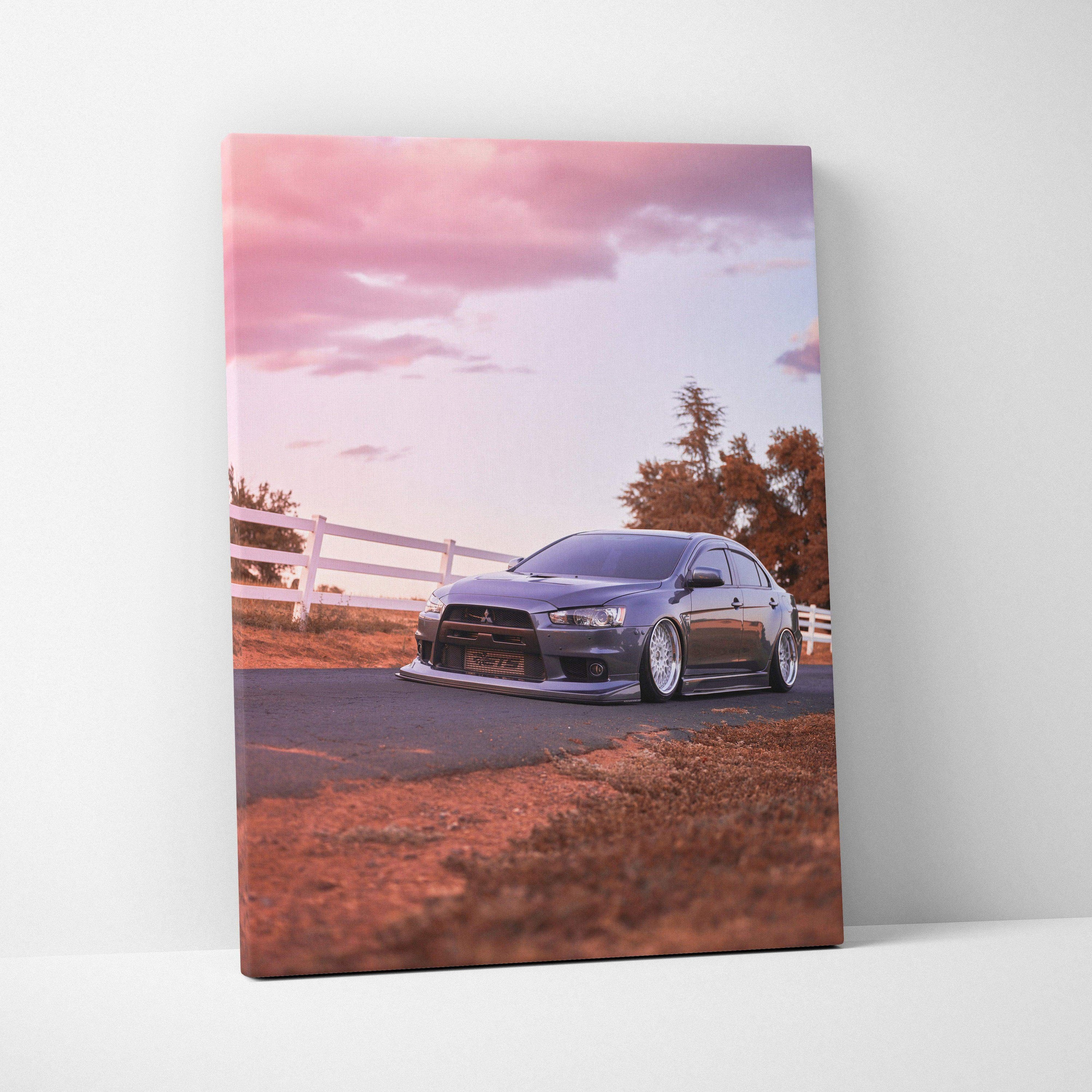 Vertical canvas art featuring a Mitsubishi Evo 10 on a road at sunset with warm tones and soft sky.