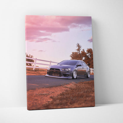 Vertical canvas art featuring a Mitsubishi Evo 10 on a road at sunset with warm tones and soft sky.