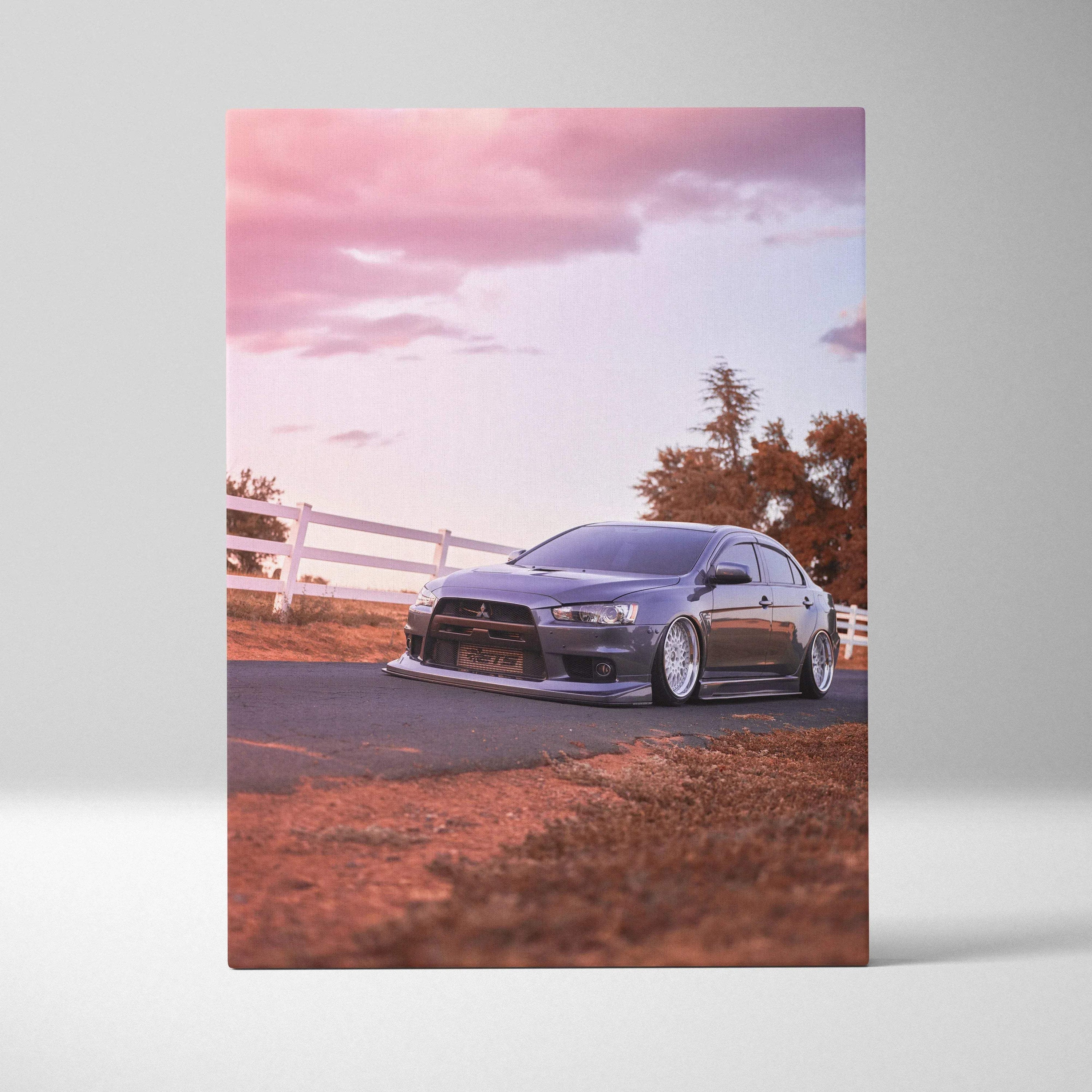 Mitsubishi Evo 10 parked on road during sunset with pink sky canvas wall art.