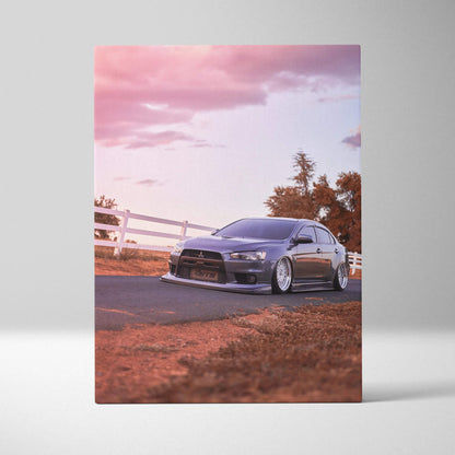 Mitsubishi Evo 10 parked on road during sunset with pink sky canvas wall art.
