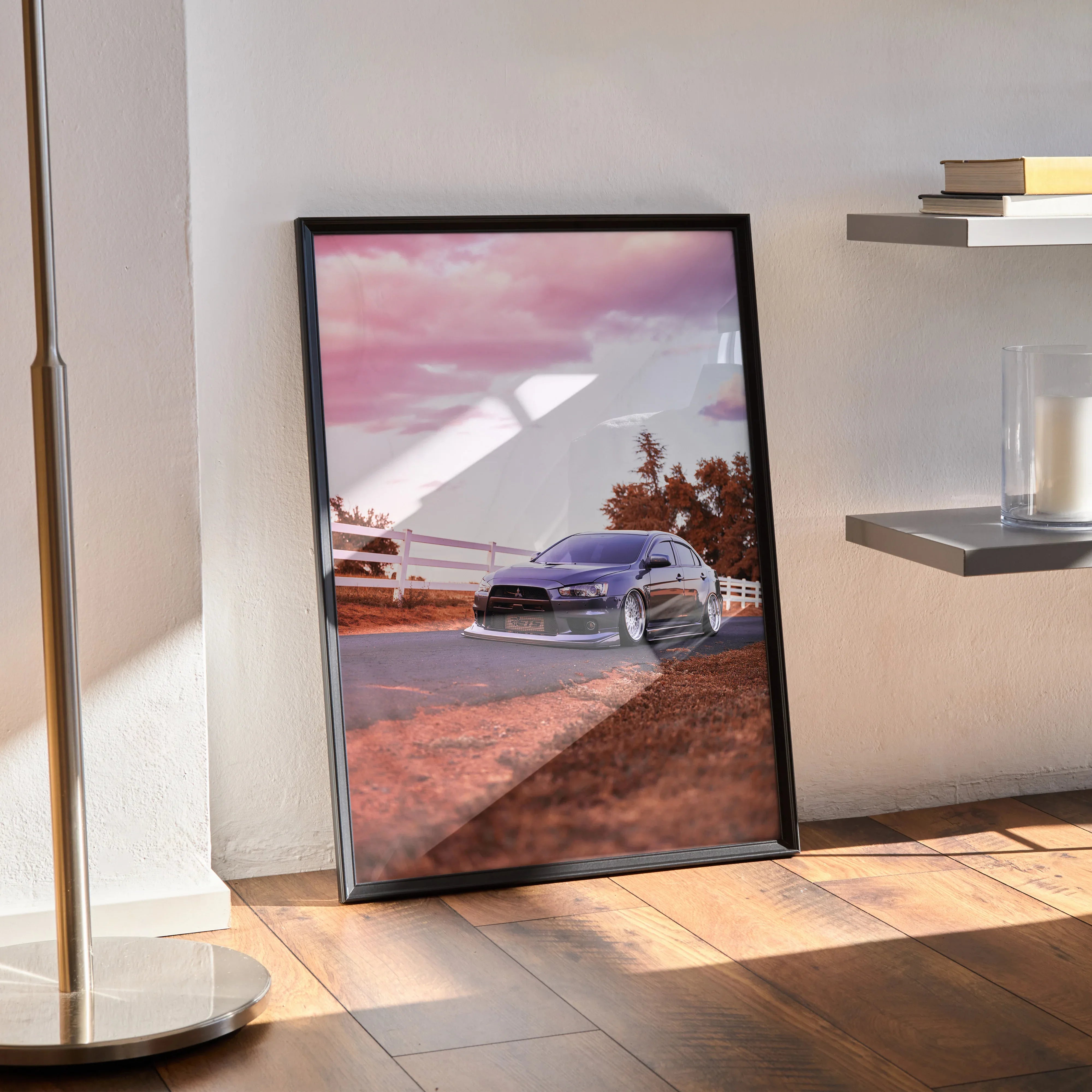 Mitsubishi Evo 10 car poster with pink sunset sky, framed wall art leaning on floor.