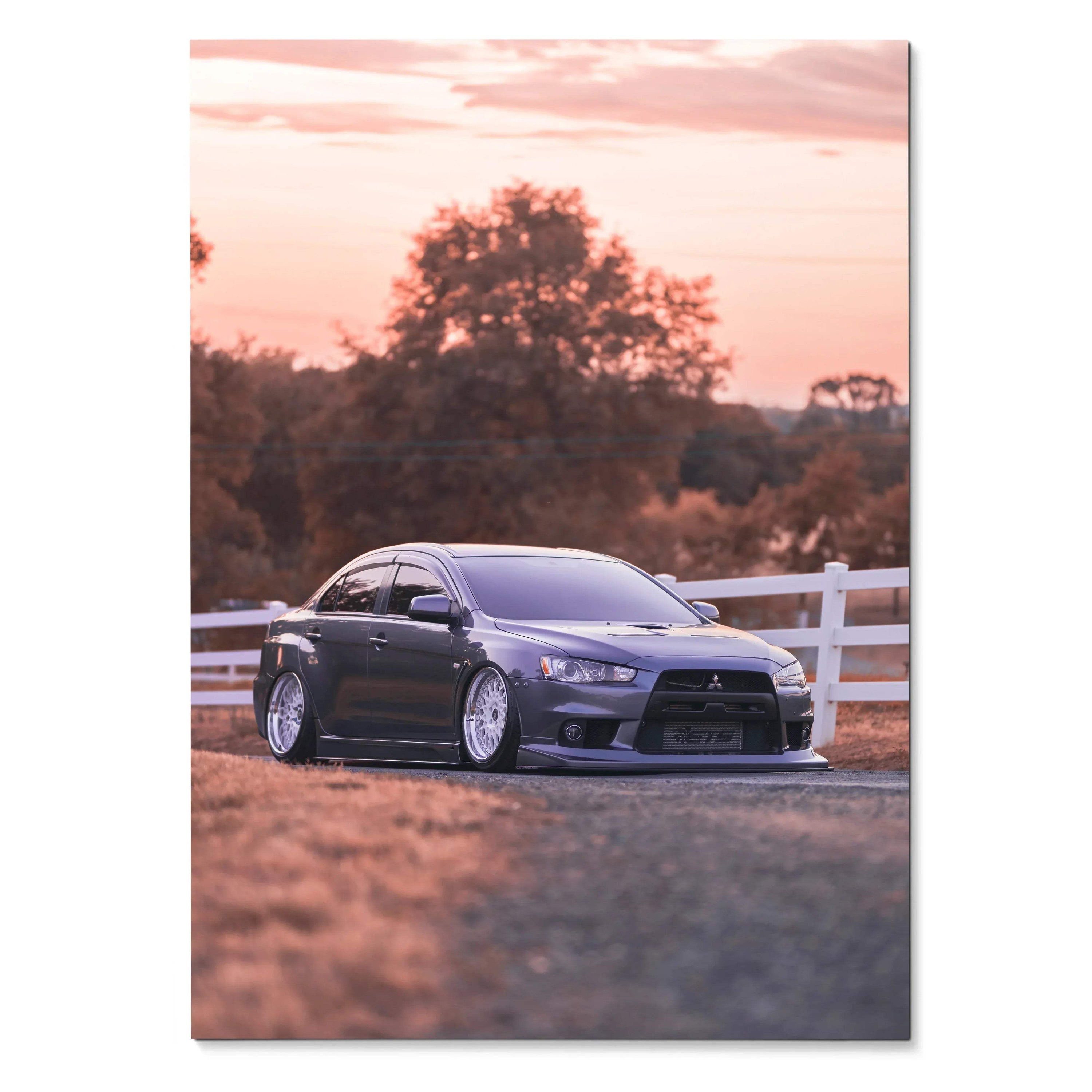 Mitsubishi Evo 10 parked by white fence at sunset wall art poster with warm tones.