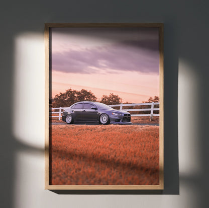 Mitsubishi Evo 10 parked by white fence sunset poster wall art in wooden frame.