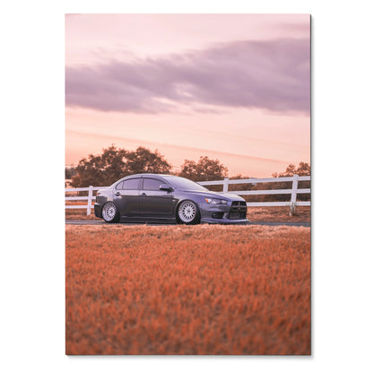 Mitsubishi Evo 10 parked in orange field under pink sky poster wall art.