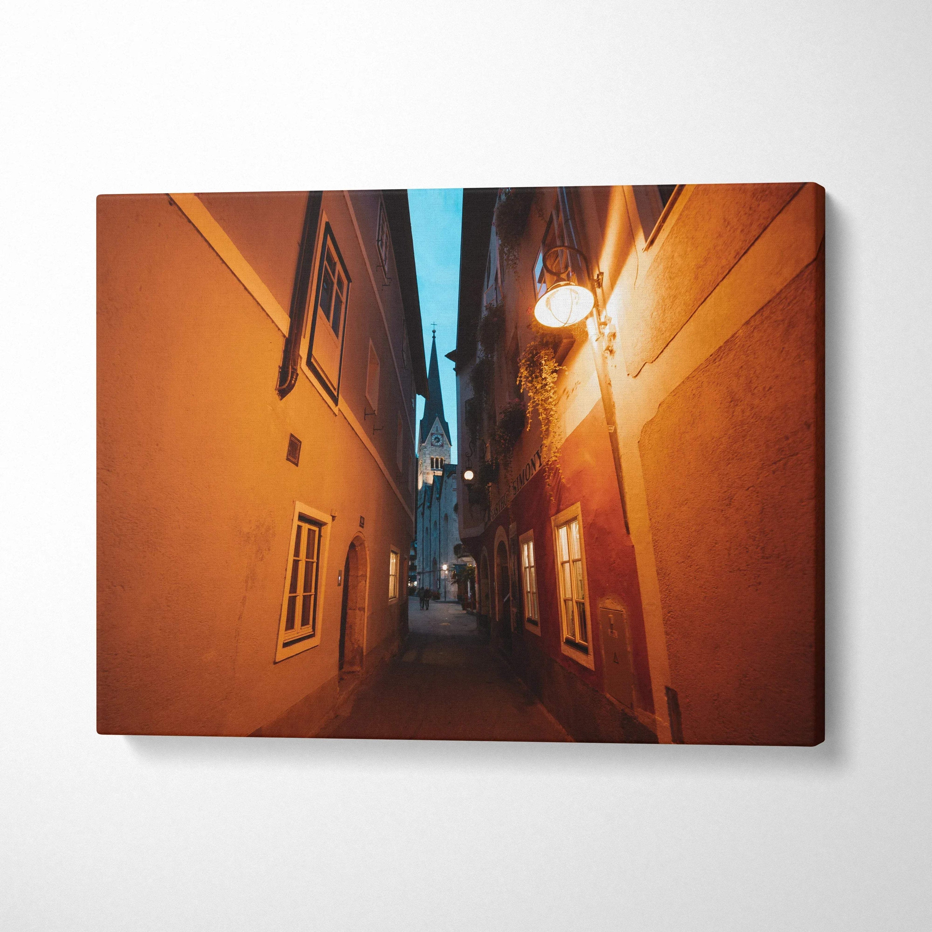 Narrow urban alleyway with warm street lighting on canvas wall art print.