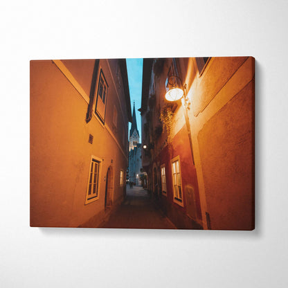 Narrow urban alleyway with warm street lighting on canvas wall art print.