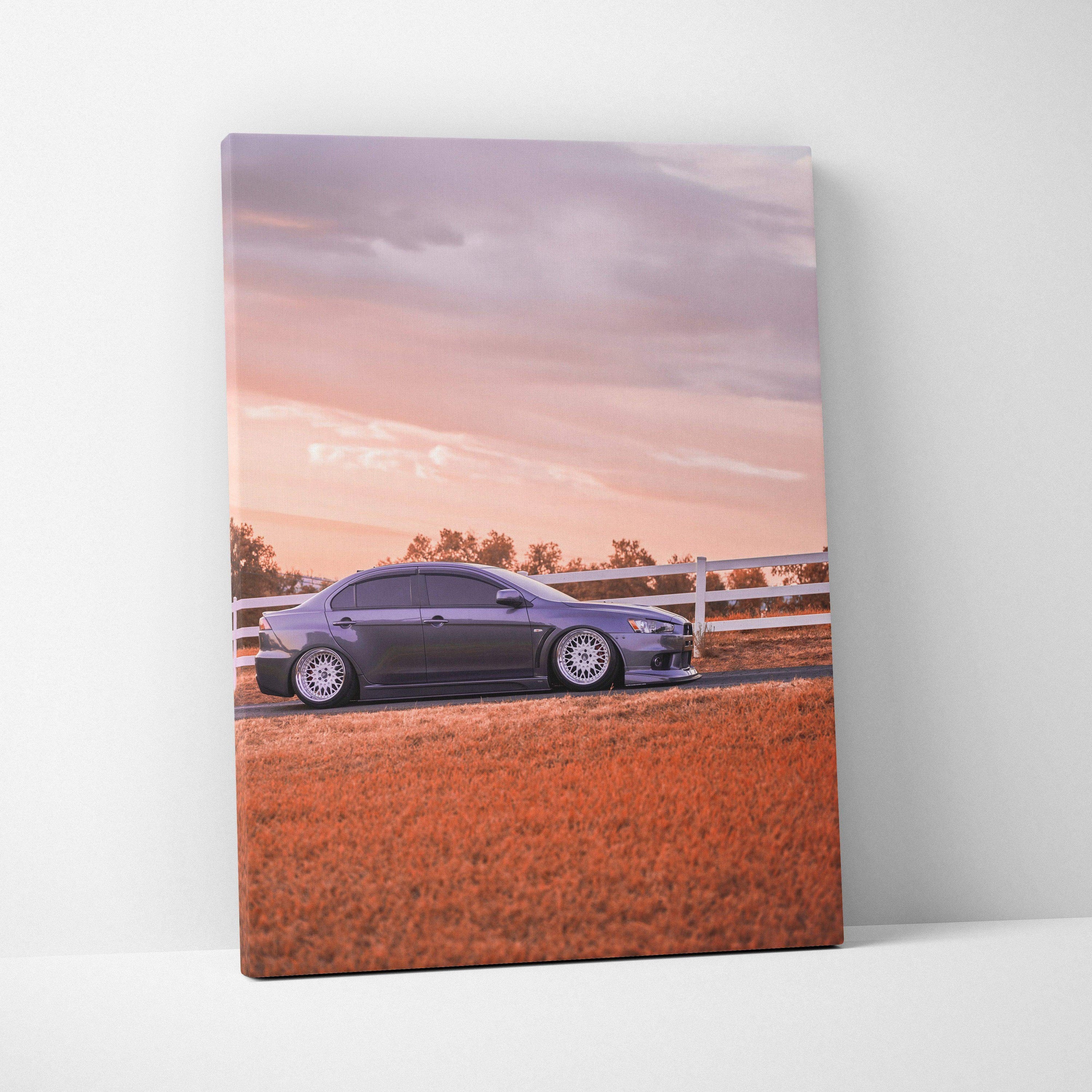 Mitsubishi Evo 10 parked by white fence at sunset landscape canvas wall art.
