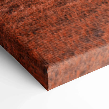 Close-up of textured rust-colored canvas wall art with rich, earthy tones and detailed fabric weave.
