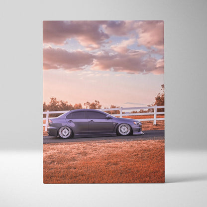 Vertical canvas art featuring a Mitsubishi Evo 10 in sunset with a scenic fence background.