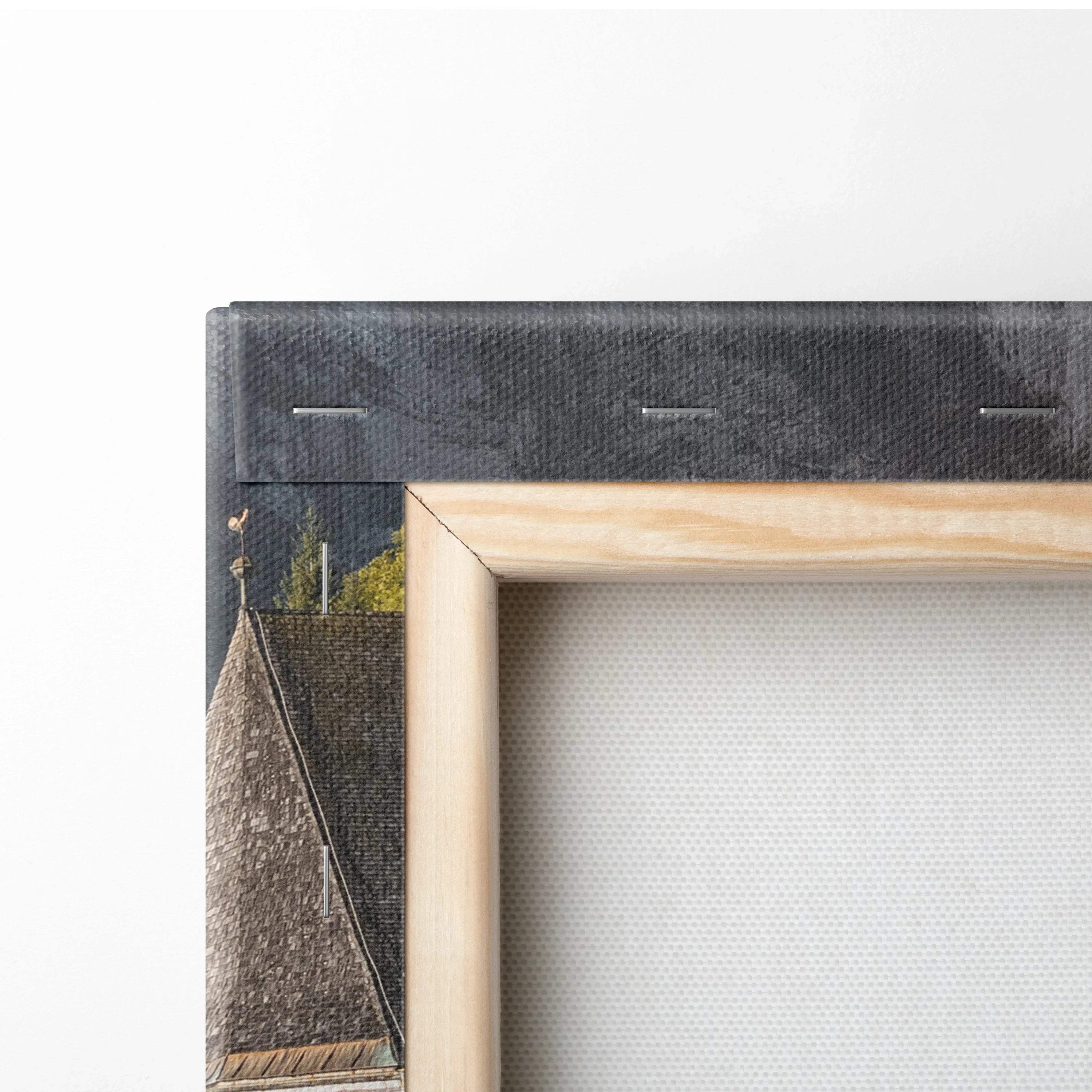 Close-up of corner of canvas wall art showing wooden frame and textured digital architectural print with dark and earthy.