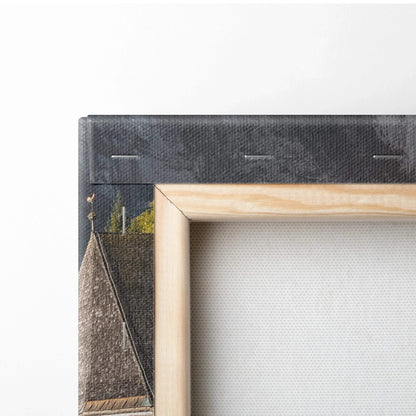 Close-up of corner of canvas wall art showing wooden frame and textured digital architectural print with dark and earthy.