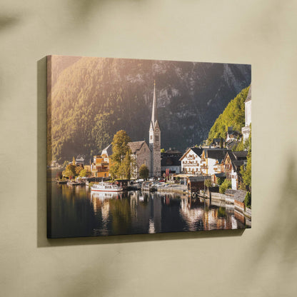 Canvas wall art featuring a serene lakeside village with mountains and a church steeple at sunset.