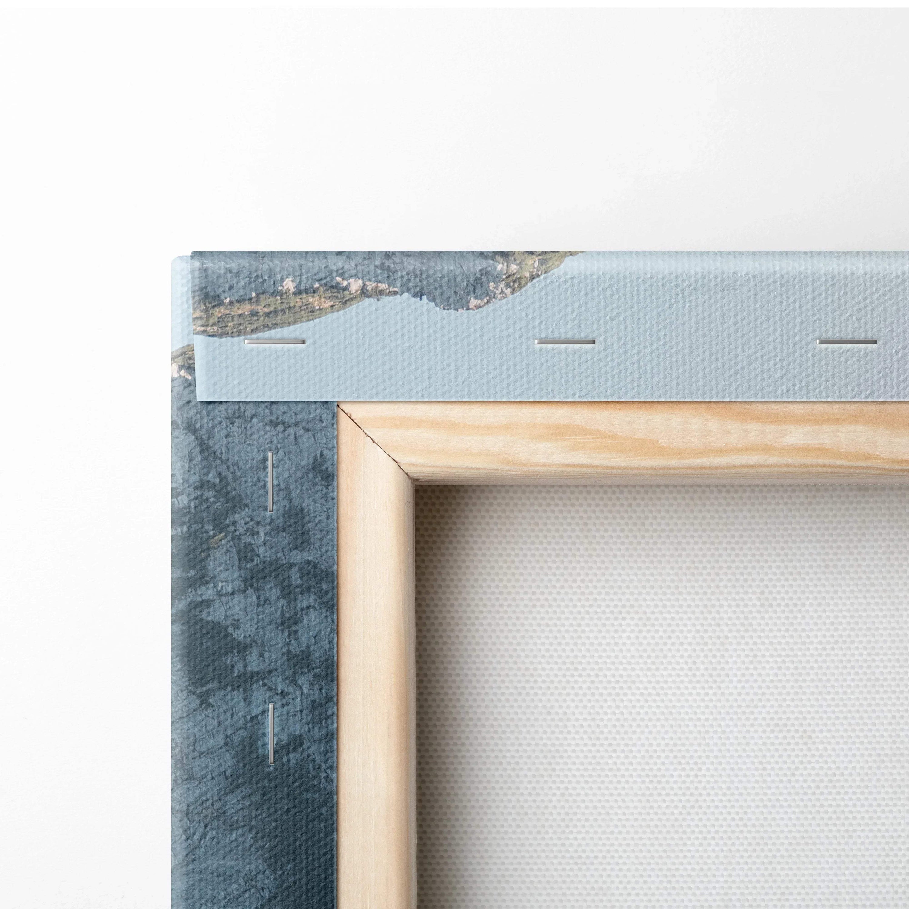 Close-up of a stretched canvas on a wooden frame with blue textured edges and visible staples securing the canvas.
