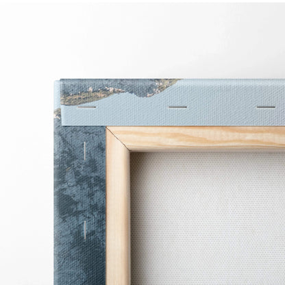 Close-up of a stretched canvas on a wooden frame with blue textured edges and visible staples securing the canvas.