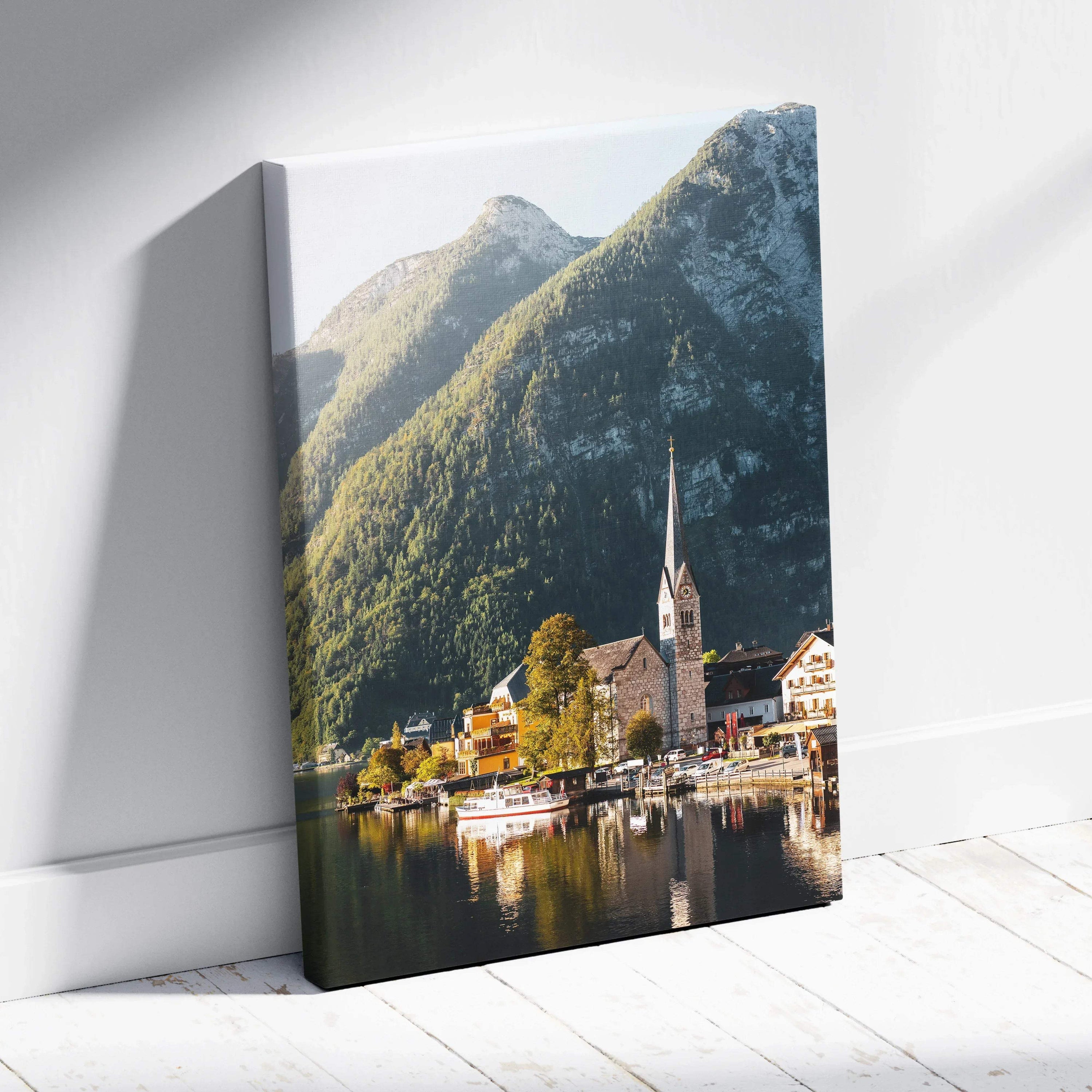 Canvas art wall decor featuring a scenic lakeside village with mountains and church steeple.